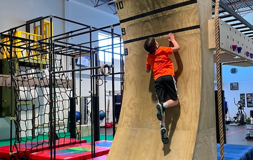 Kids conquering ninja warrior obstacle course