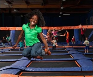 Kids bouncing and flipping at indoor trampoline park